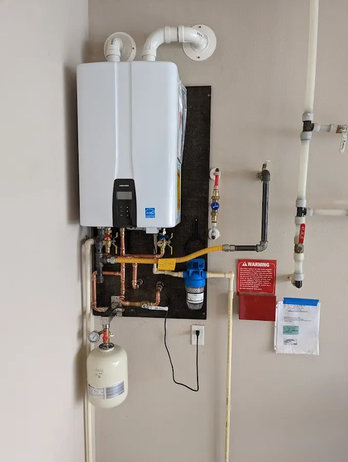 Professional plumber installing copper piping in a Washington home